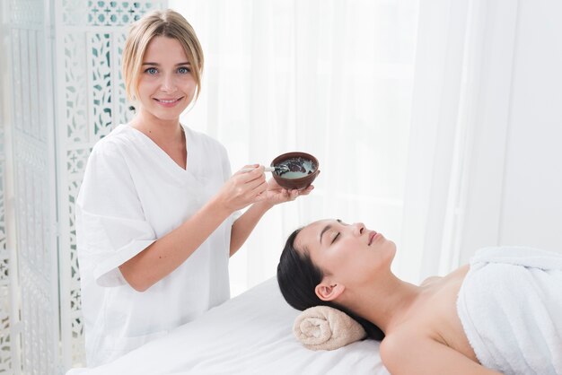 Woman with a facial mask in a spa