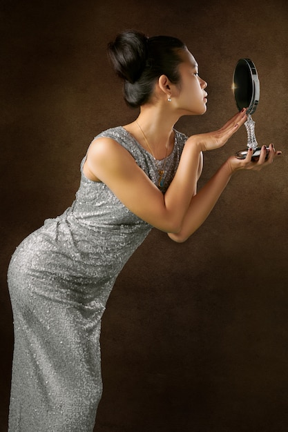 Free photo woman with facing mirror