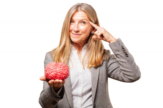 Woman with a finger on a pig's temple and piggy bank