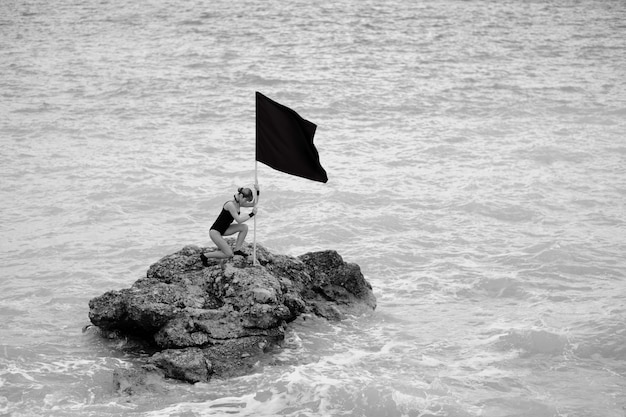 Woman with a flag in a rock