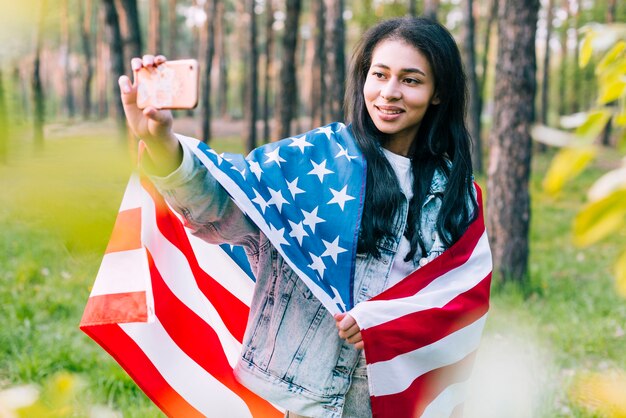 Woman with flag taking selfie