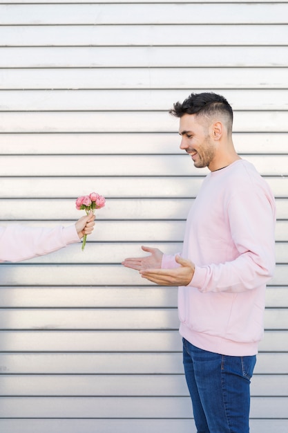 Woman with flowers near happy man