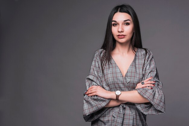 Woman with folded arms looking at camera