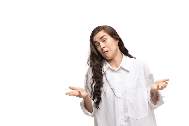 Woman with funny meme emotions on white wall