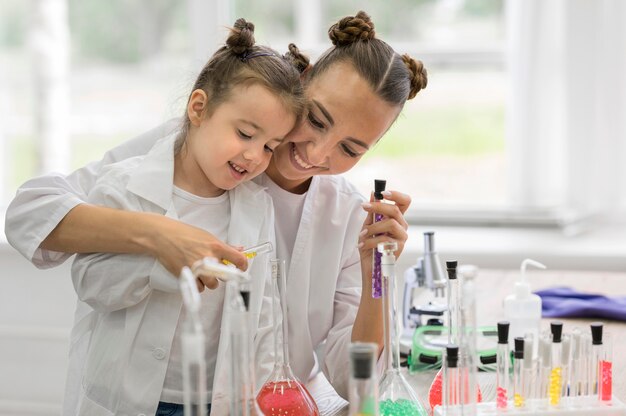 Woman with girl in lab doing experiments