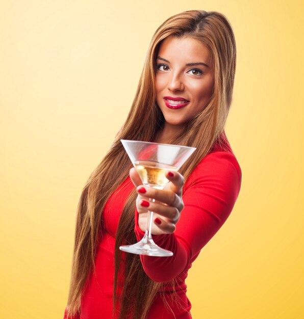 Woman with a glass in a yellow background