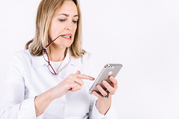 Woman with glasses browsing smartphone