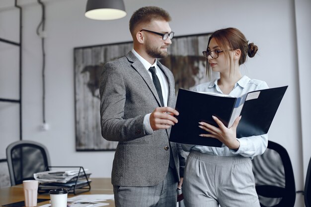 Woman with glasses.Businessman with documents.Colleagues work together