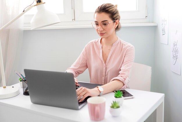Woman with glasses working on laptop