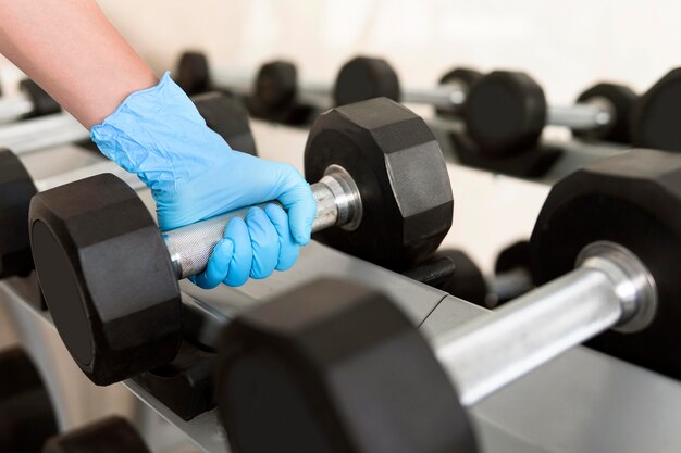 Woman with glove grabbing weight