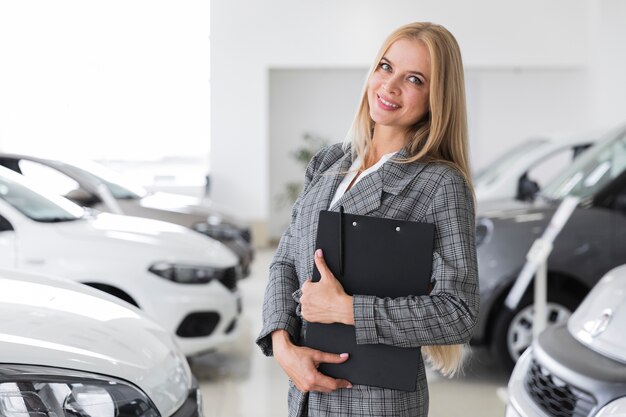 Woman with gray coat at dealership