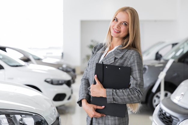 Woman with gray coat at dealership