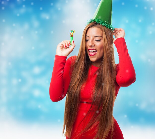 Woman with green hat while snowing