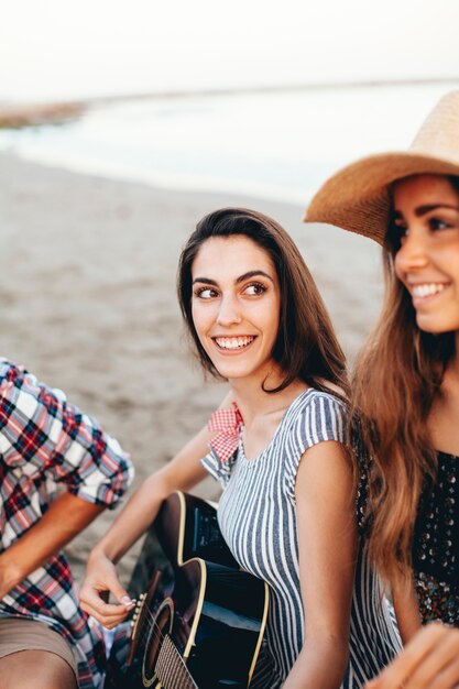 Woman with guitar looking at her friend