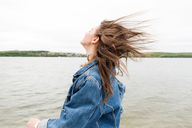 Woman with hair blown by wind