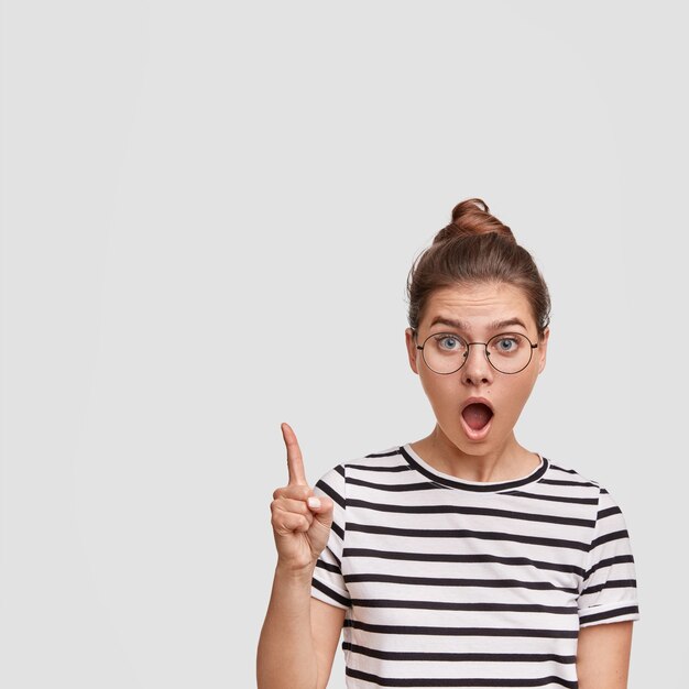 Woman with hair in a bun wearing striped T-shirt