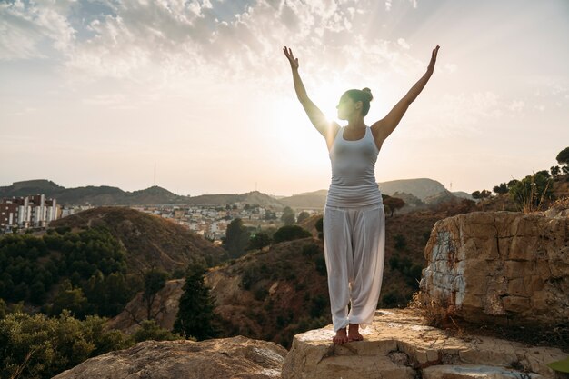 Woman with hands up during yoga session