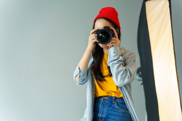 Free photo woman with hat taking photos