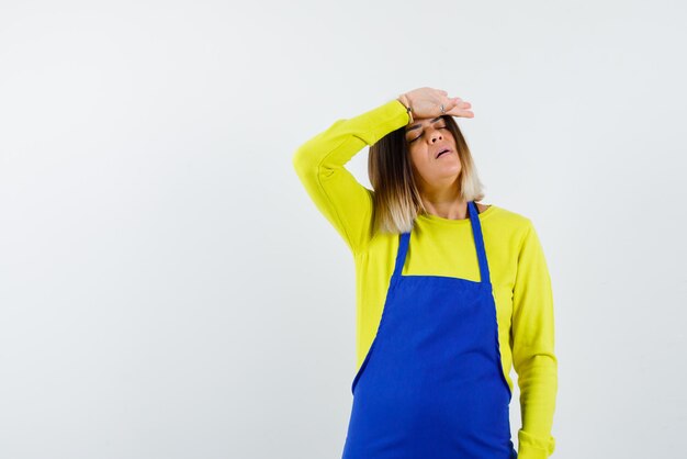 The woman with headache is putting her hand on forehead on white background