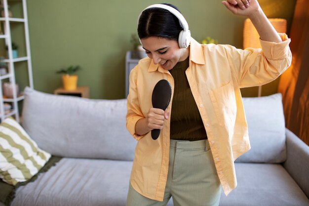 Woman with headphones and brush, singing