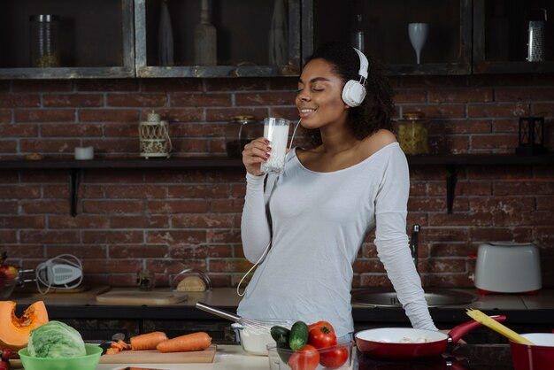 Woman with headphones drinking