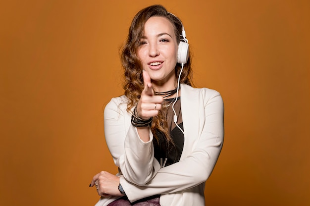 Free photo woman with headphones pointing