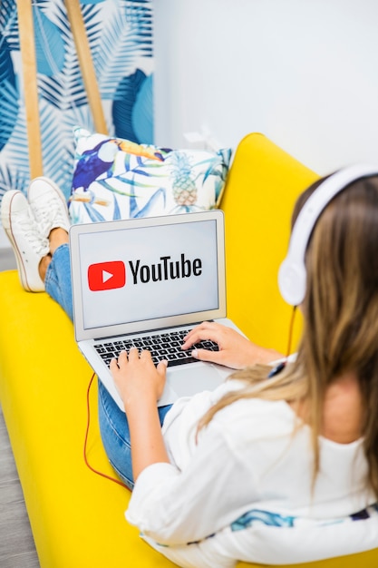 Woman with headphones watching in laptop 