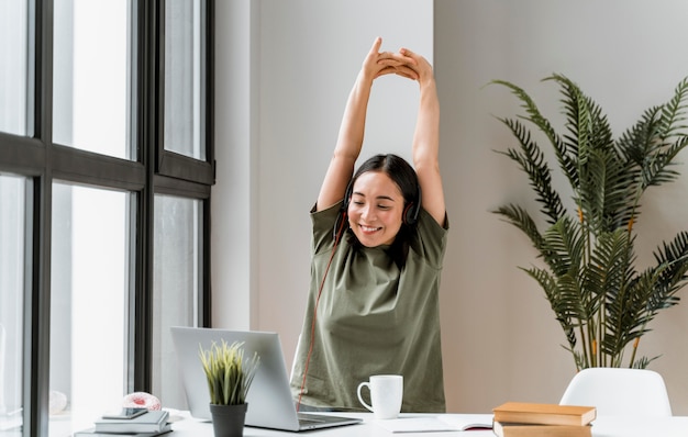 Woman with headset having video call on laptop