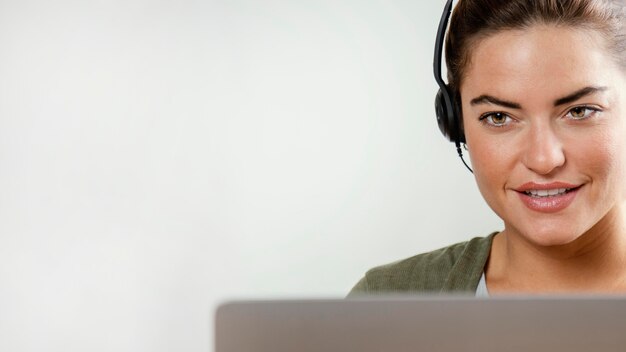 Woman with headset using laptop