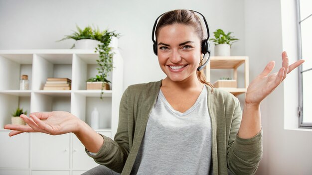 Woman with headset using laptop