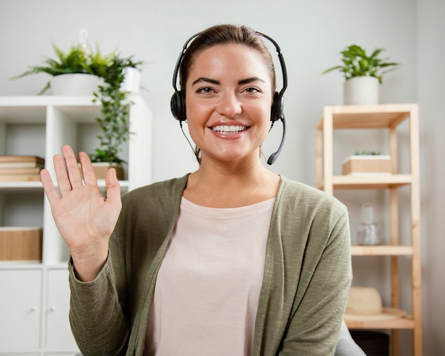 Woman with headset waving