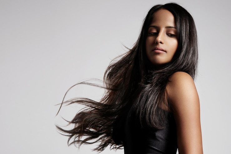 Free Photo woman with healthy brunette hair in studio shoot