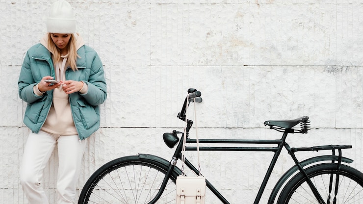 Free Photo woman with her bike taking a break front view