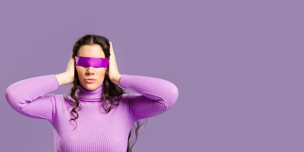 Woman with her eyes covered and copy space