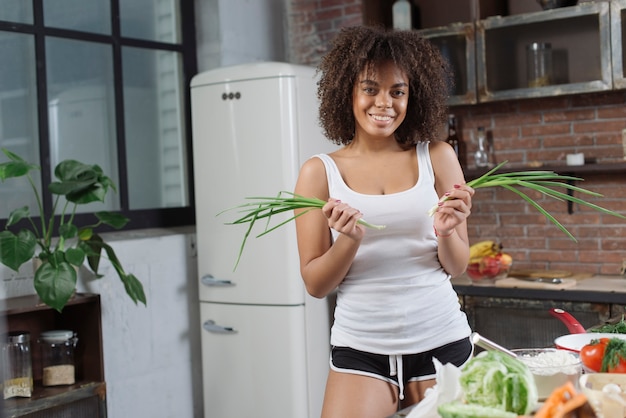 Woman with herbs in kitchen