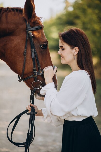 Woman with horse in forest