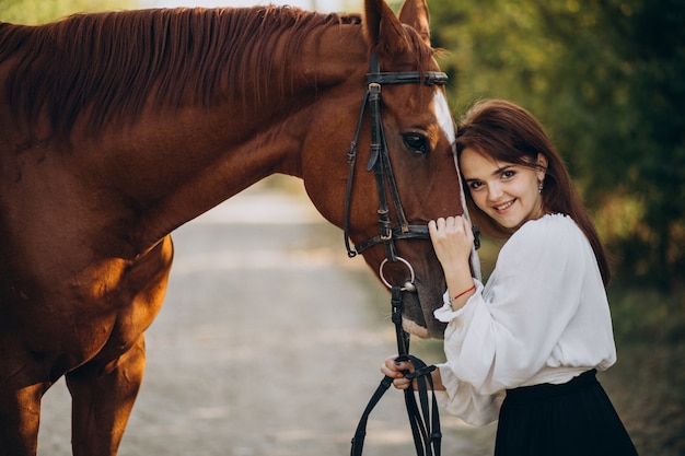 Woman with horse in forest