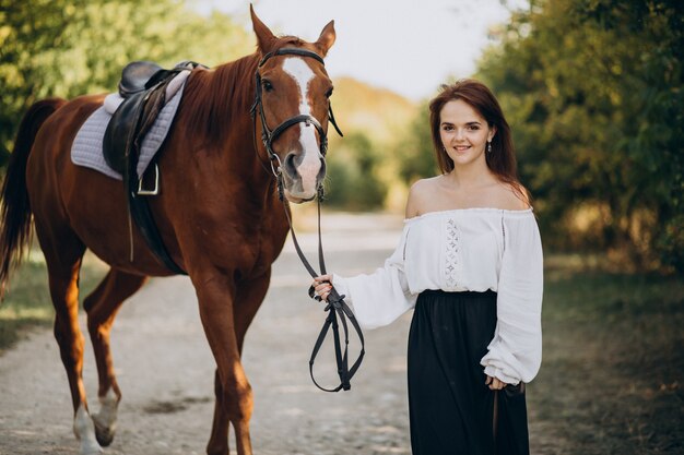 Woman with horse in forest