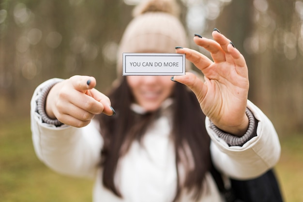 Free photo woman with inspirational writing pointing at camera