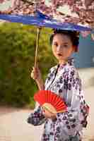 Free photo woman with kimono and wagasa umbrella