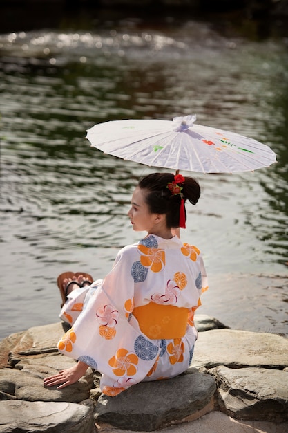 Free photo woman with kimono and wagasa umbrella