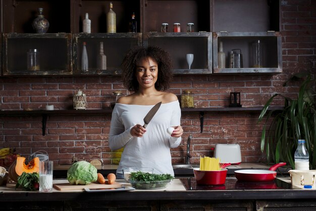 woman with knife in kitchen