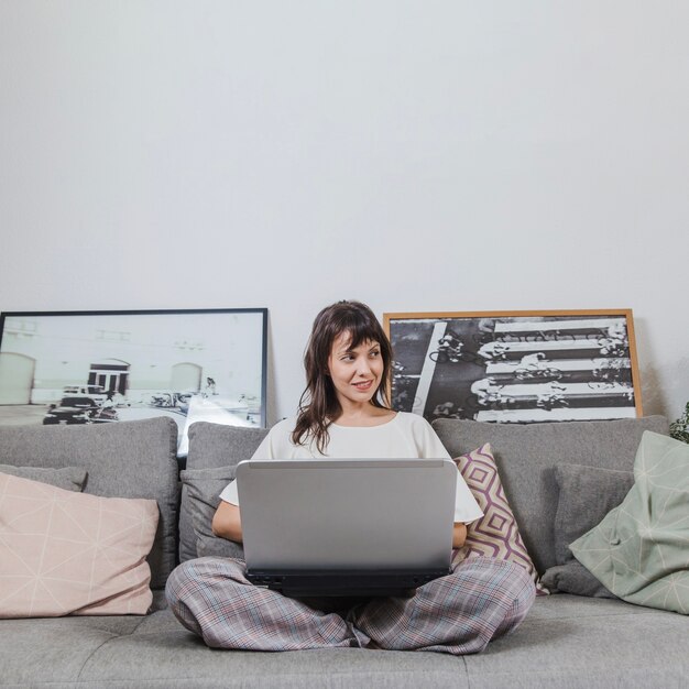 woman with laptop on couch