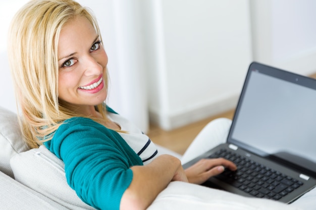 Woman with laptop looking at camera