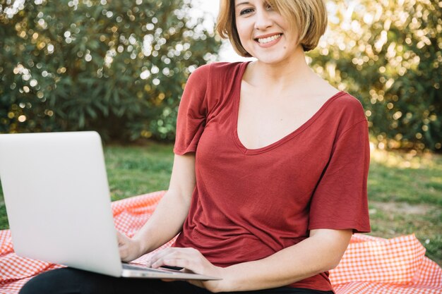 Woman with laptop looking at camera