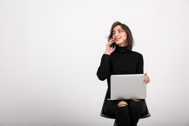 Woman with laptop sitting isolated