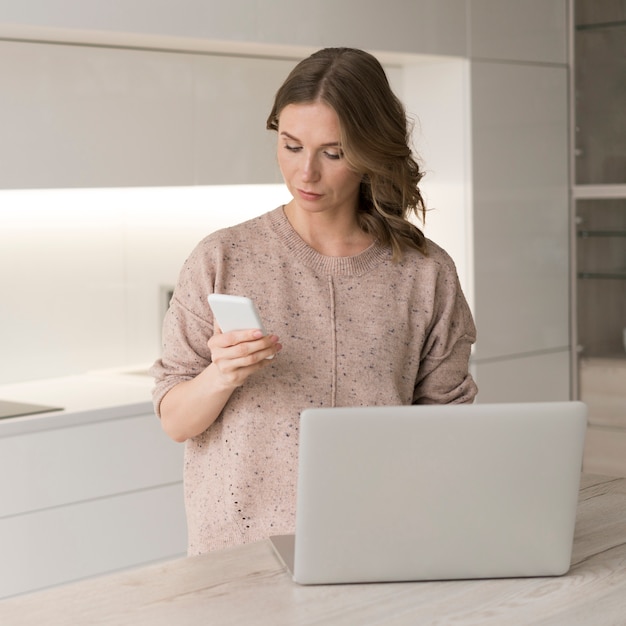 Woman with laptop and smartphone