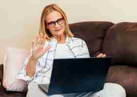 Free photo woman with laptop working at home during quarantine