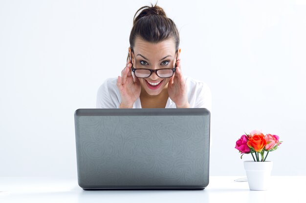 Woman with laptop working at home