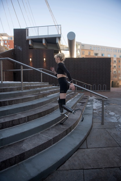 Woman with leg disability running in the city